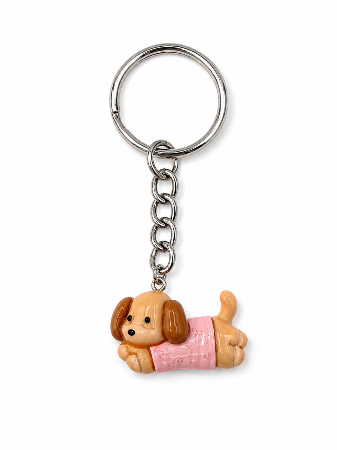 A dachshund-shaped keychain charm wearing a pink sweater, attached to a silver metal split ring and chain, shown on a plain white background.