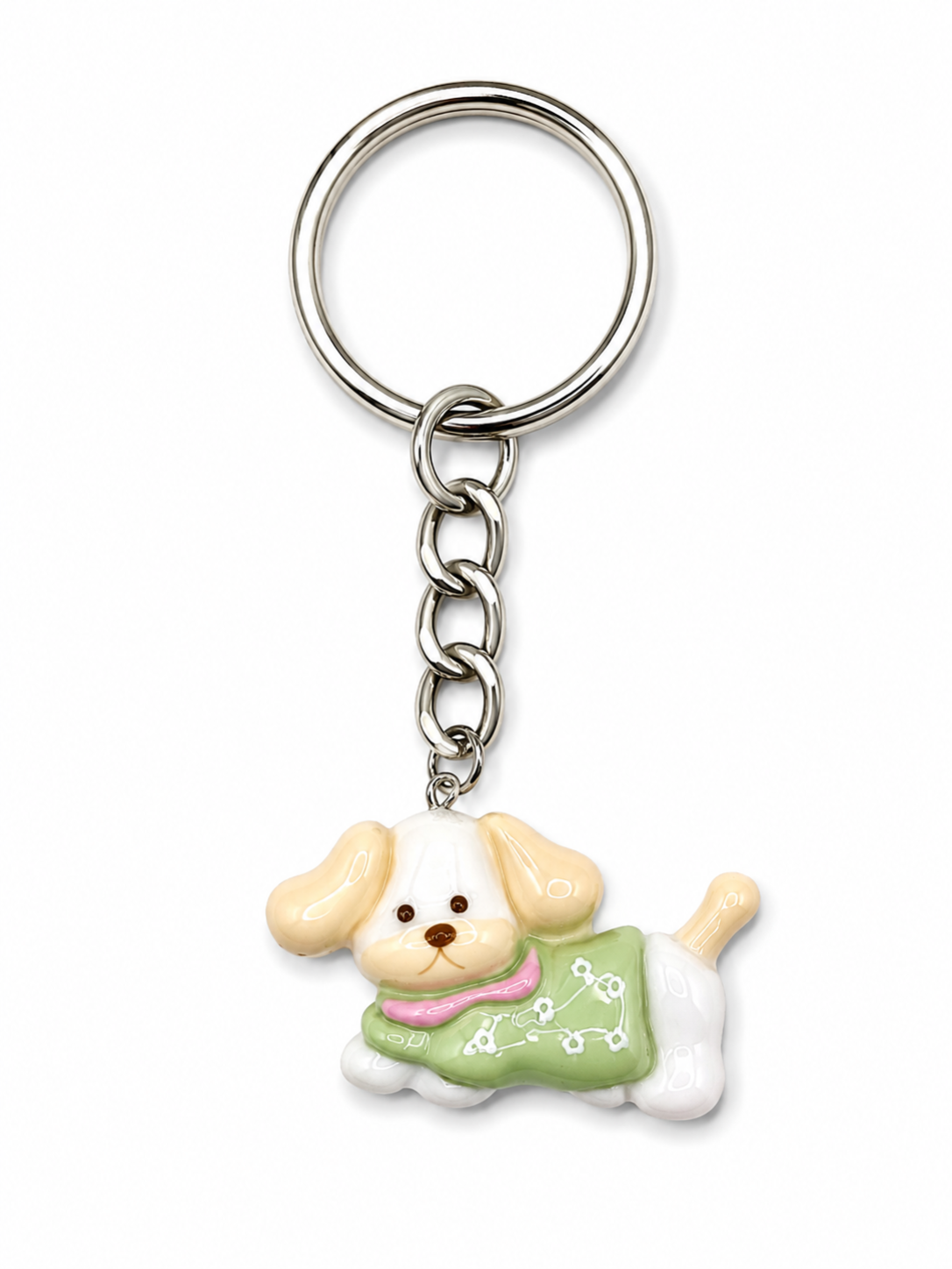 A metal keychain with a charm shaped like a small cream-colored dog wearing a light green sweater with white paw prints and a pink collar, shown on a plain white background.